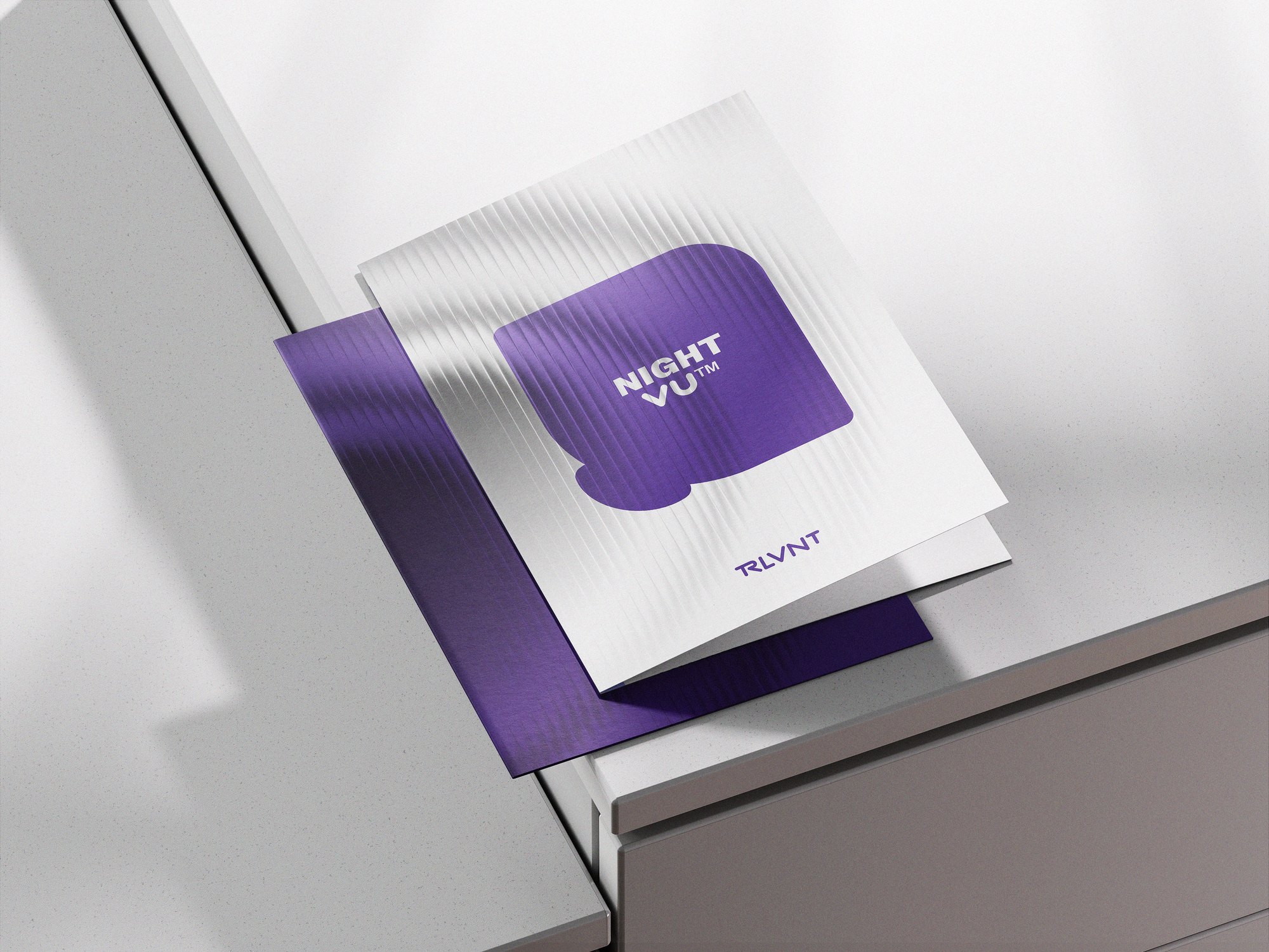 RLVNT NightVU branding — folded brochure cover mockup