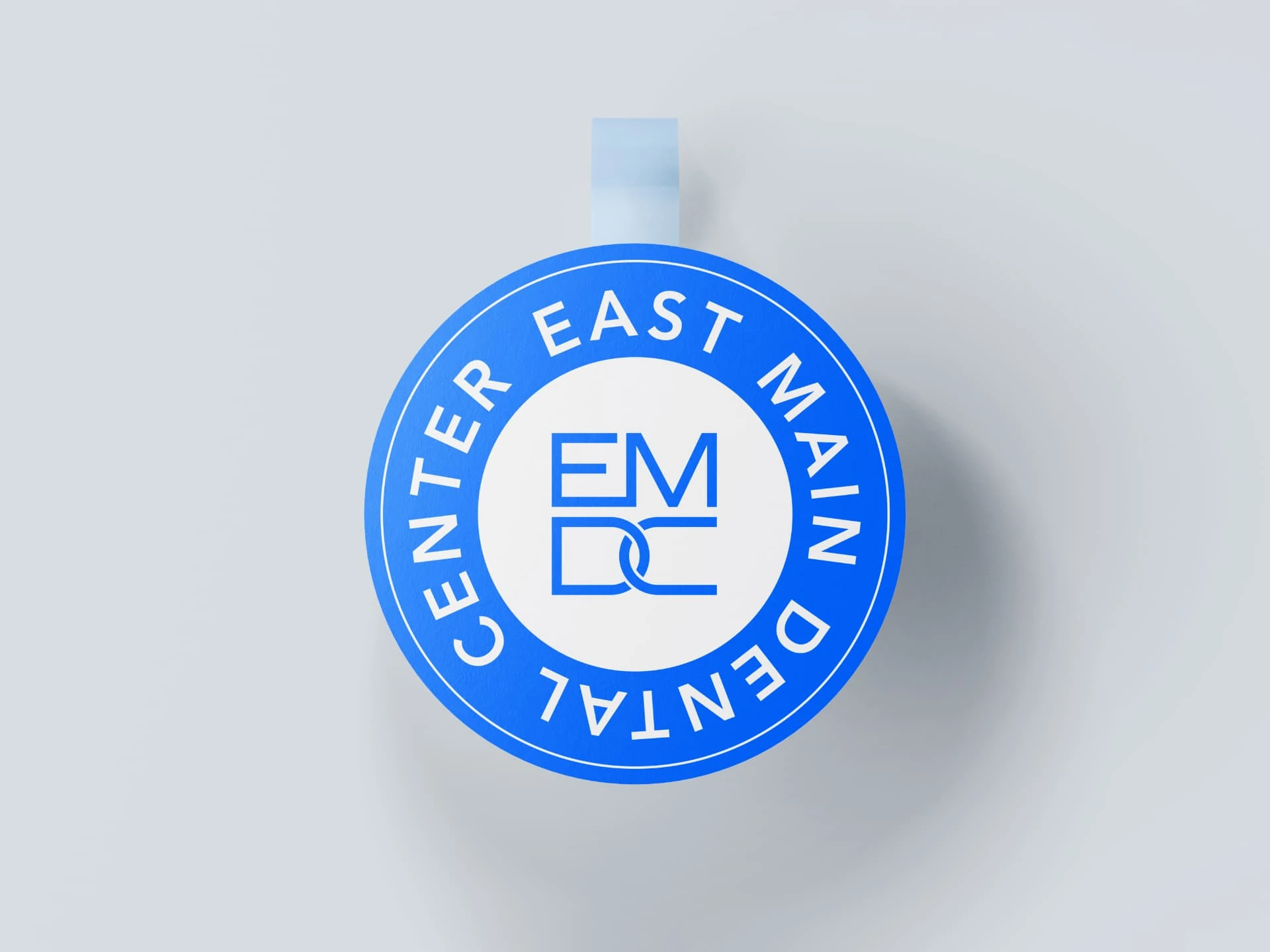 East Main Dental Center branding — circular promotional wobbler mockup