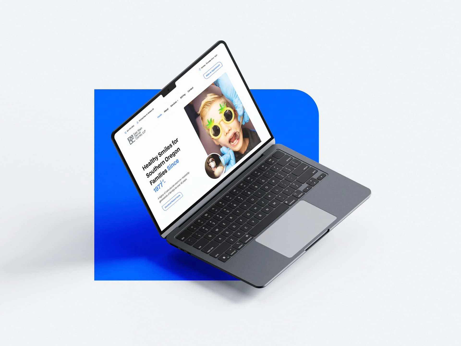 East Main Dental Center website — laptop mockup with the blue brand system