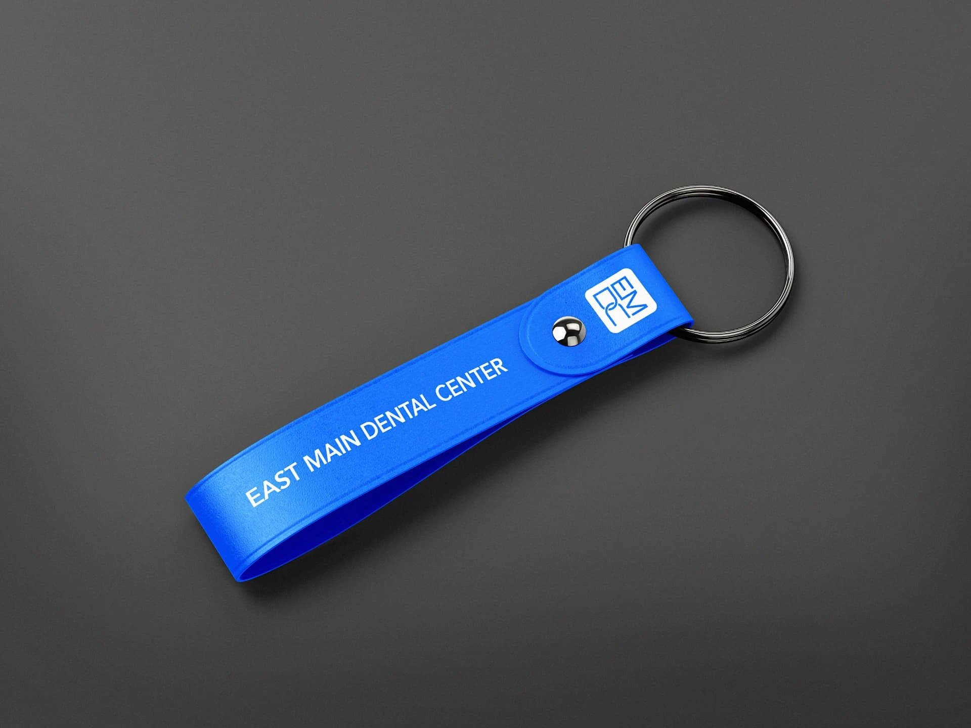 East Main Dental Center branding — blue strap keychain mockup