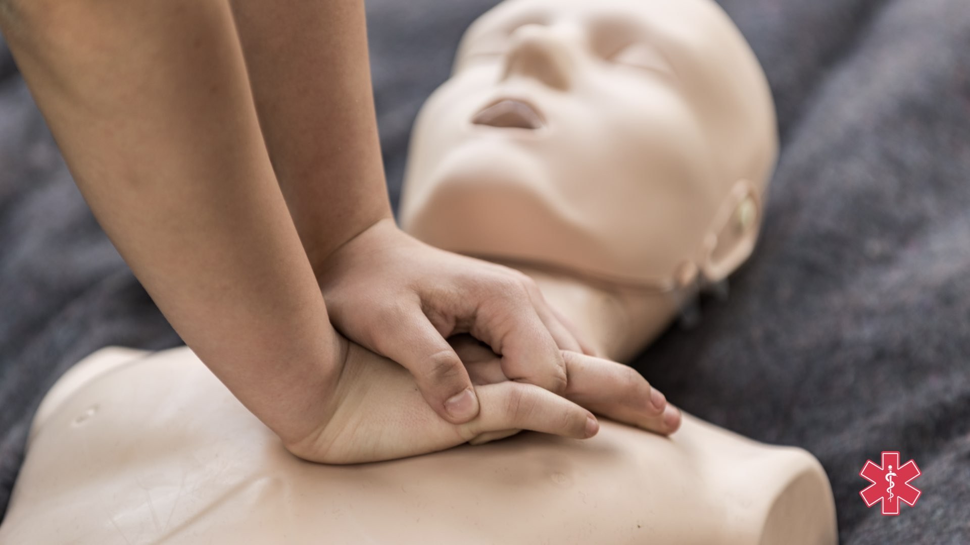CPR training photo with the First Response Star of Life emblem.